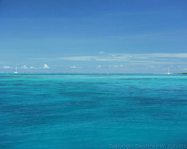 Boats Anchored Behind Reef