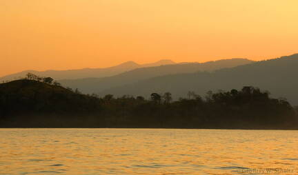 Hazy orange sunrise at Punta Naranjo